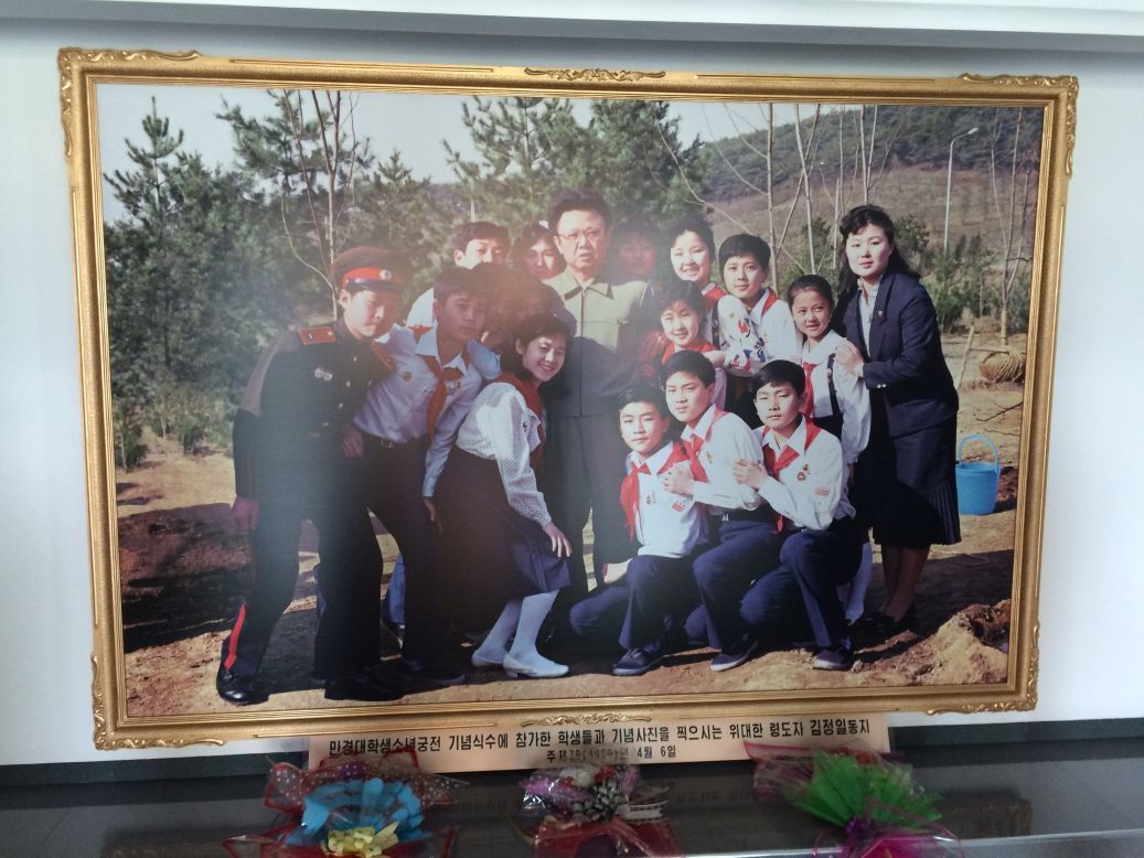 A photo of late North Korean leader Kim Jong Il posing with students sits in the lobby of a Pyongyang elementary school.