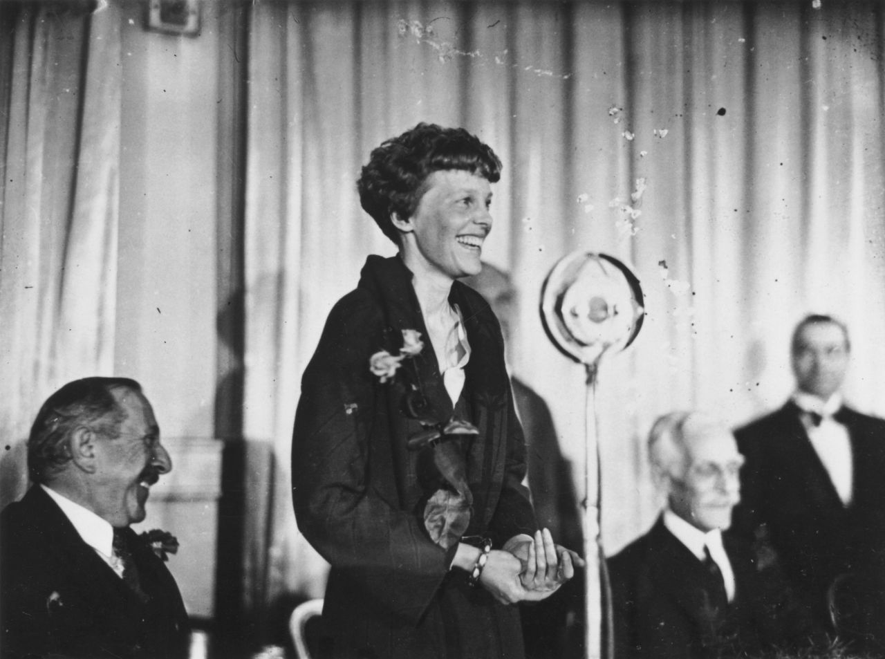 Earhart addresses journalists during a lunch in London on May 23, 1932. Her triumphant crossing was not without difficulties. Shortly after taking off from Newfoundland, she encountered thick clouds and ice on the wings of her plane. Mechanical problems later in the flight informed her decision to land in Northern Ireland.