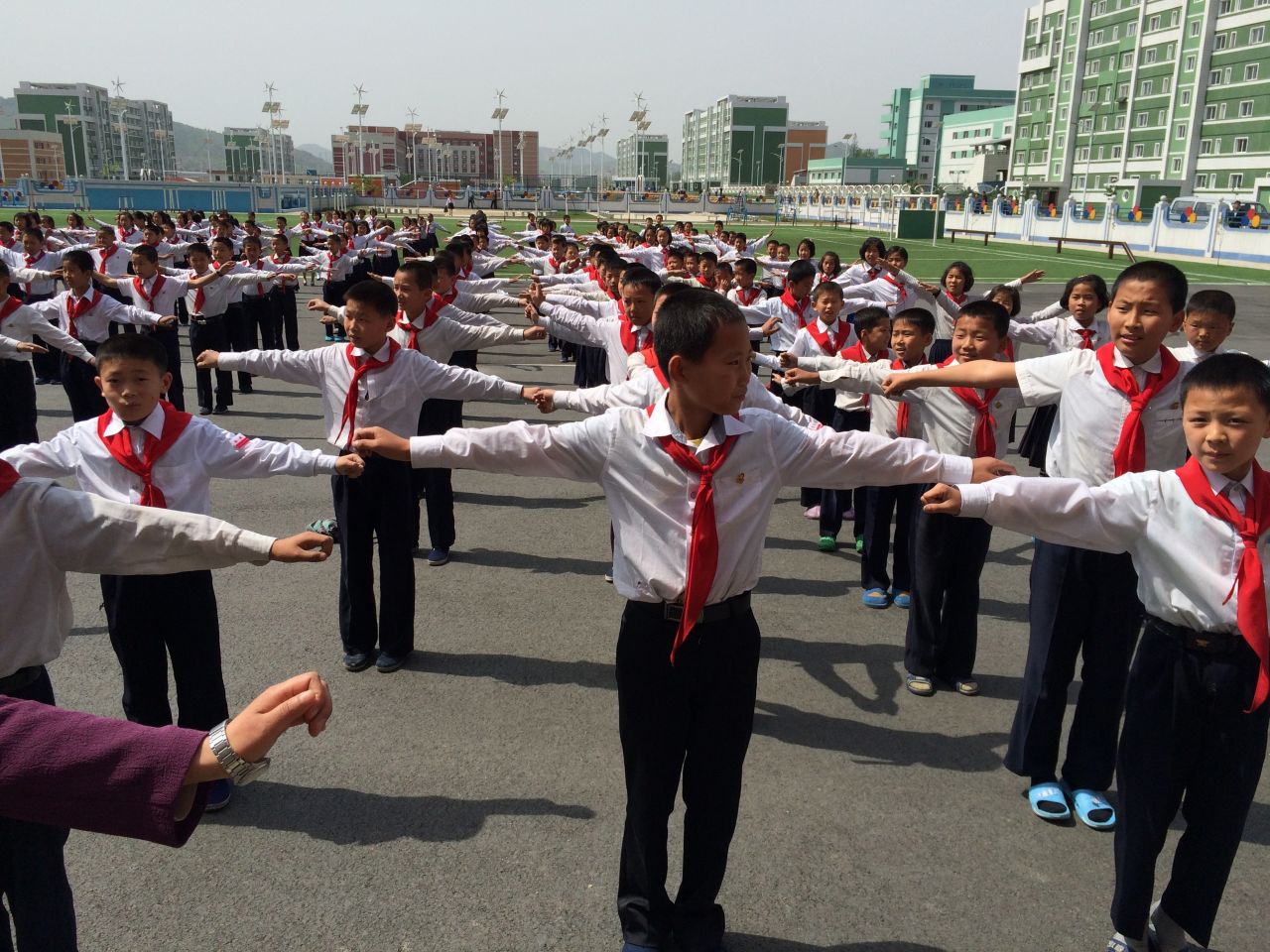 Outdoor exercise accompanied by upbeat music is a daily routine for these North Korean middle school students. Classes are critiqued on their coordination.   
