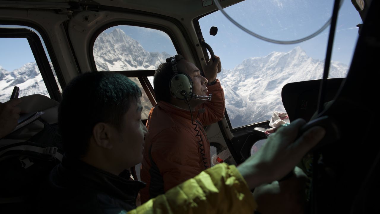 Phurba Sherpa anxiously peers out the window of a helicopter ferrying him to a remote Sherpa village high in the Himalayas. He wanted to assess the damage wrought by the April 25 earthquake in Nepal.