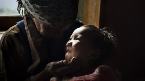 The mother of Dawa Chiri Sherpa cares for his 18-month-old daughter after the climbing guide was killed by a quake-triggered avalanche at Everest Base Camp.