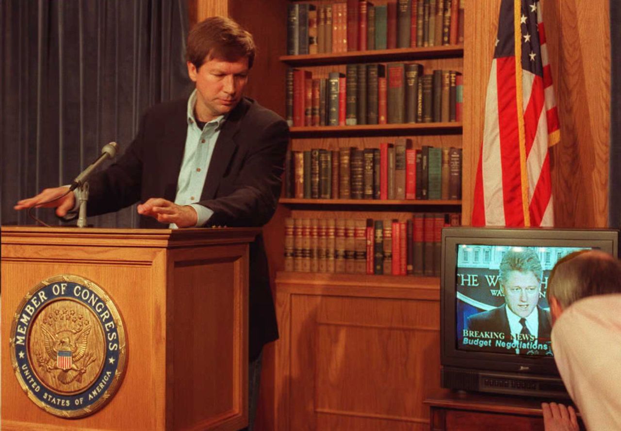 Kasich shows a videotape of President Bill Clinton speaking during a news conference on Capitol Hill on December 16, 1995. Kasich was chairman of the House Budget Committee at the time and disputed Clinton's position on the budget.