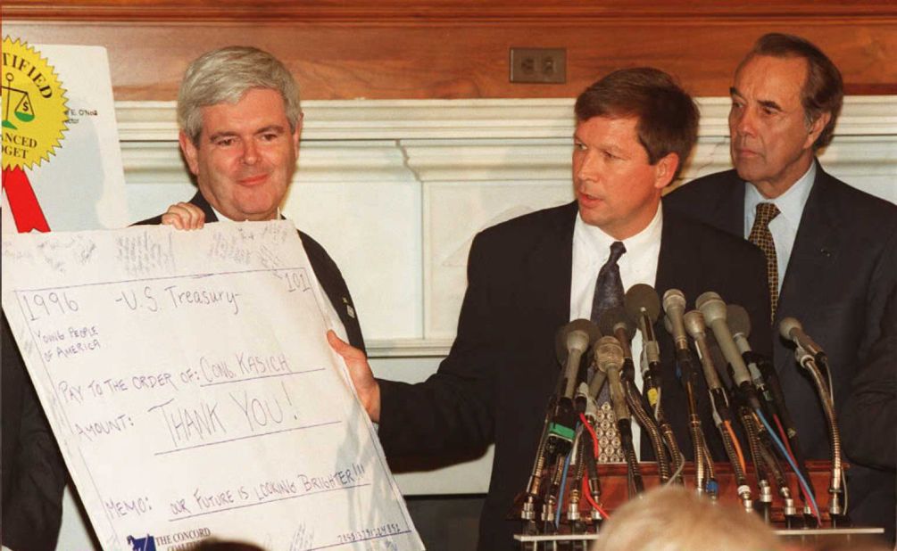 Kasich, center, shows a thank you note in the form of a check to Speaker of the House Newt Gingrich, left, and Senate Majority Leader Robert Dole (right) on November 17, 1995, in Washington. They were soon engaged in bruising battles with President Bill Clinton over the federal budget. 