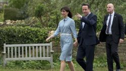 Britain's Prime Minister and Conservative Party leader David Cameron and his wife Samantha arrive to vote at a polling station in Spelsbury, England, as they vote in the general election, Thursday, May 7.