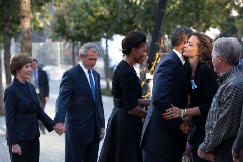 Greeting families with former first lady Laura Bush (from left), former President George W. Bush and first lady Michelle Obama before a commemoration ceremony on the 10th anniversary of the 9/11 terrorist attacks in New York on September 11, 2011. 