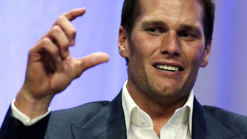 New England Patriots quarterback Tom Brady gestures during an event at Salem State University in Salem, Mass., Thursday, May 7, 2015. An NFL investigation has found that New England Patriots employees likely deflated footballs and that quarterback Tom Brady was "at least generally aware" of the rules violations. The 243-page report released Wednesday, May 6, 2015, said league investigators found no evidence that coach Bill Belichick and team management knew of the practice. (AP Photo/Charles Krupa, Pool)