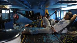 File photo from 2013: Laborers resting in their cabin aboard a trawler after it returned from the sea at a port in Pattani, southern Thailand