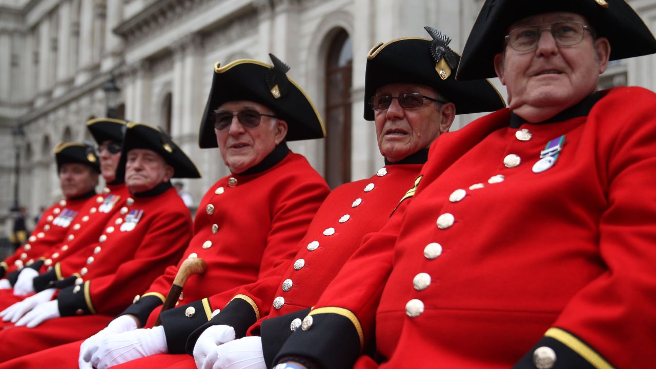 Chelsea pensioners sit on a bench for the V-E Day celebration in London.