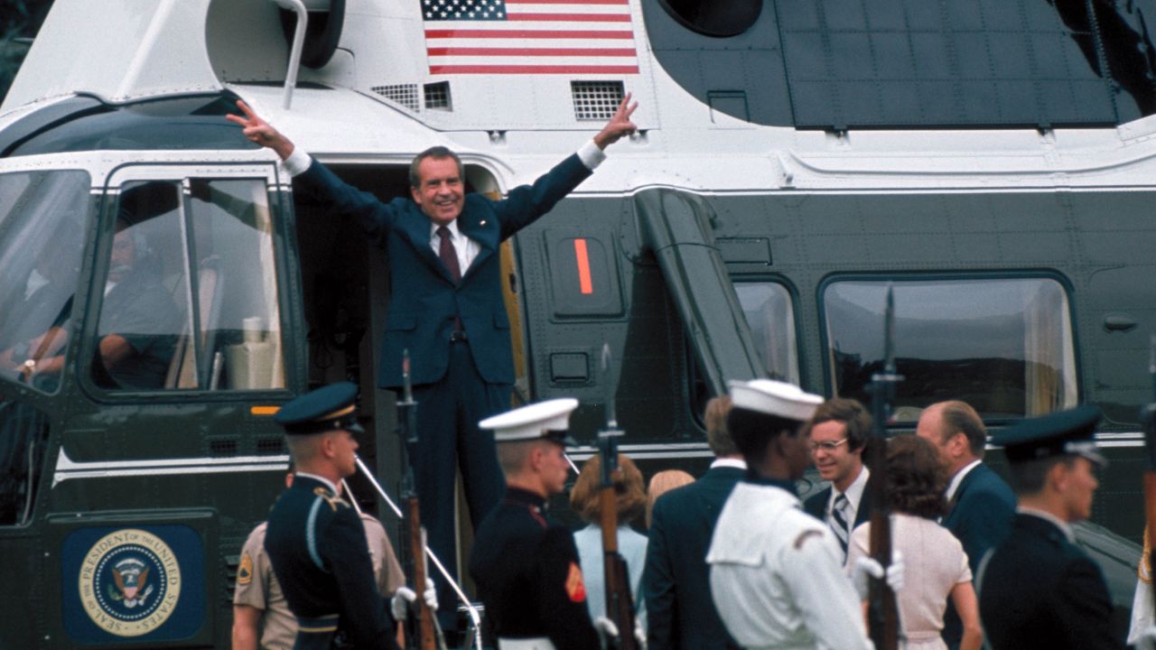 U.S. President Richard Nixon gestures in the doorway of a helicopter on August 9, 1974, after leaving the White House following his resignation over the Watergate scandal. Nixon's resignation marked the end to one of the biggest political scandals in U.S. history, which began in 1972 after a break-in at the Democratic National Committee's headquarters at the Watergate complex. Five men were arrested for the burglary, and the FBI and Washington Post reporters Bob Woodward and Carl Bernstein were able to trace them back to Nixon and the White House.