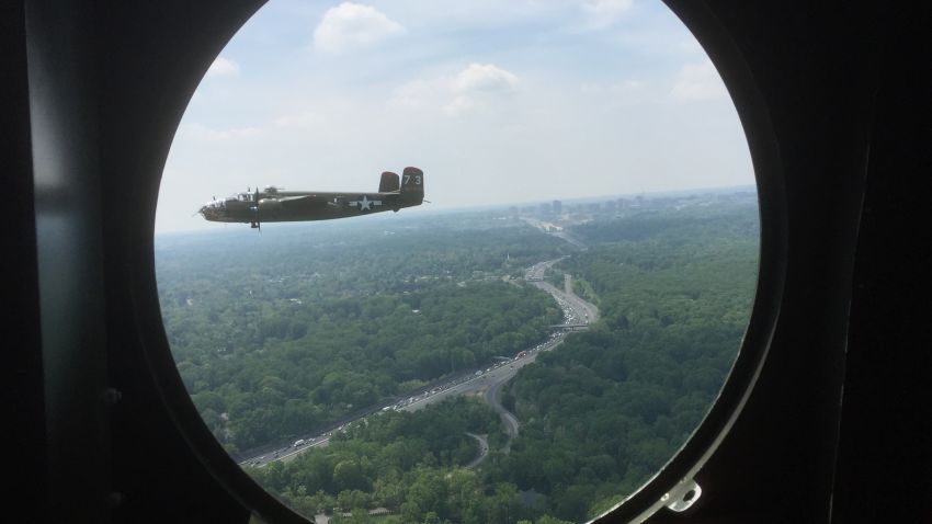 A B-25 bomber flies towards Washington, DC on May 8, 2015. Fifty-six World War II warbirds flew over the district to mark the 70th anniversary of VE Day, and the end of World War II.