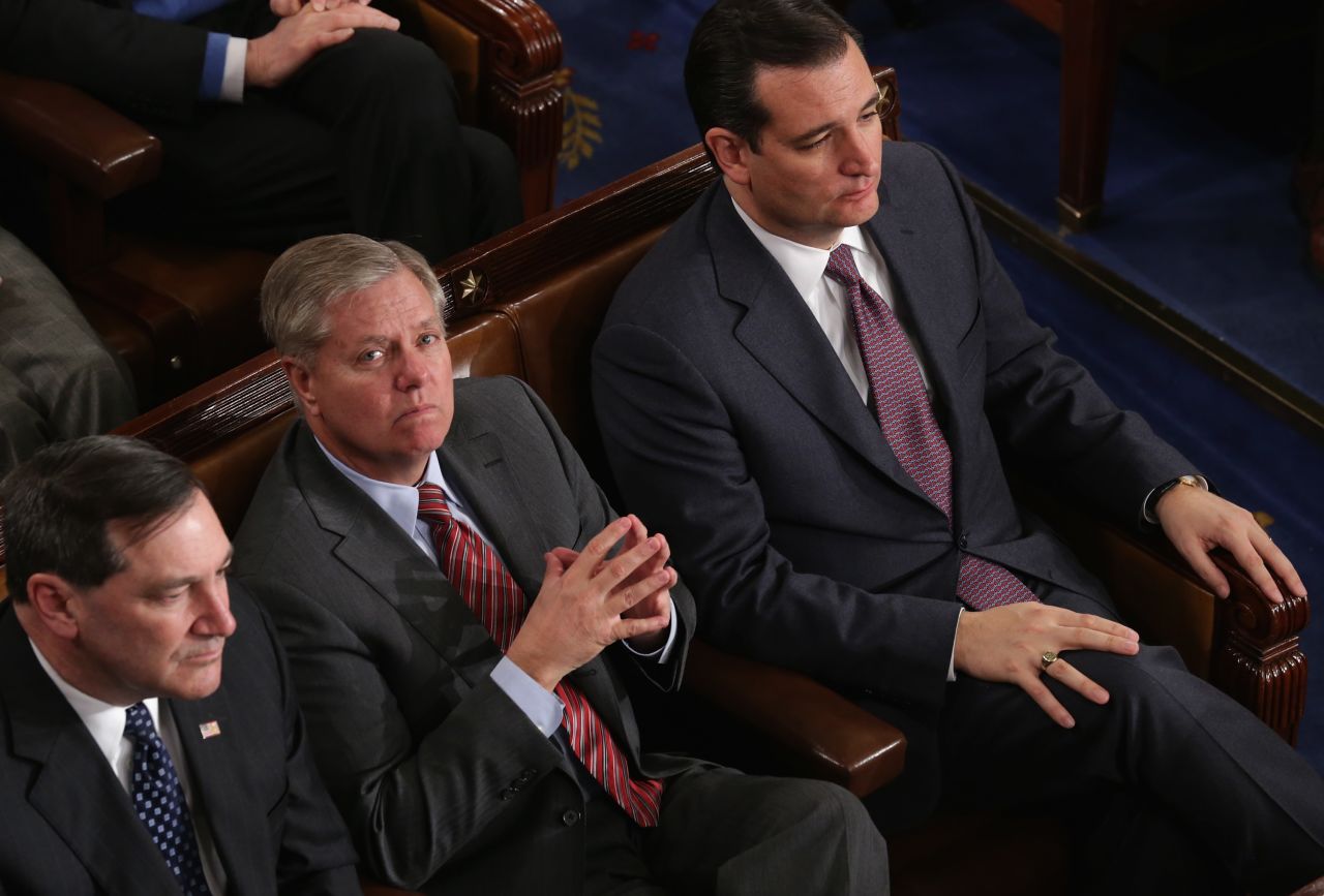 Graham and U.S. Sen. Ted Cruz, R-Texas, right, listen as President Barack Obama delivers the State of the Union address on January 28, 2014. Graham was in the U.S. Air Force and logged six-and-a-half years of service on active duty as an Air Force lawyer.