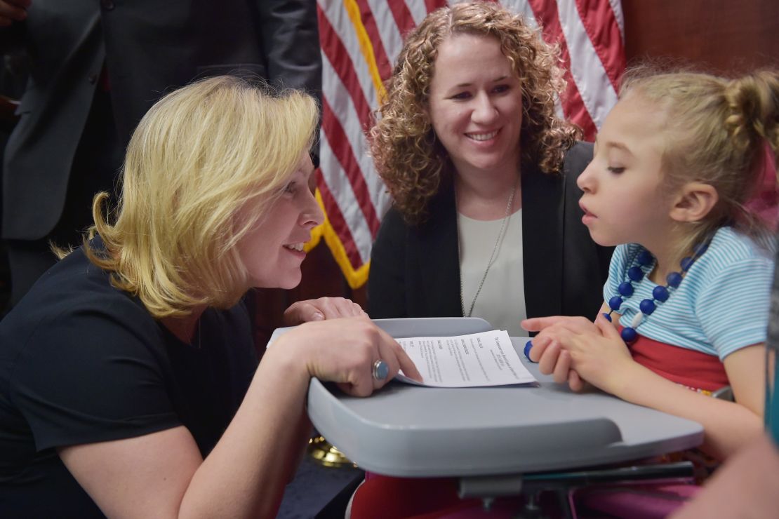 Senator Kirsten Gillibrand, D-NY, speaks to 4-year-old Morgan Hintz as her mother Kate Hintz watches. Morgan suffers from a form of epilepsy and her mother has been advocating for the use of cannabidiol for her treatment. 