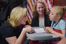 Senator Kirsten Gillibrand, D-NY, speaks to 4-year-old Morgan Hintz as her mother Kate Hintz watches. Morgan suffers from a form of epilepsy and her mother has been advocating for the use of cannabidiol for her treatment.