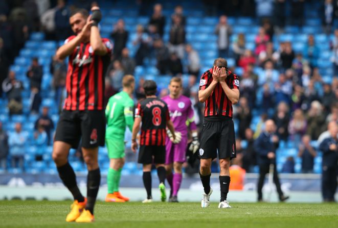 Downcast QPR players trudge off after the 6-0 defeat at Manchester City which confirmed their side's relegation.