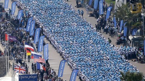 Employees of the Tiens Group, a Chinese conglomerate, attend a parade organized by CEO Li Jinyuan as part of a four-day celebration weekend for the 20th anniversary of his company, on the Promenade des Anglais, Nice, southeastern France, on May 8. 
