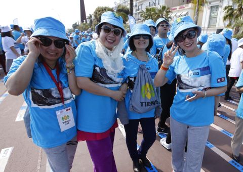 Employees of Tiens group pose for the camera during a parade in Nice, France on May 8.