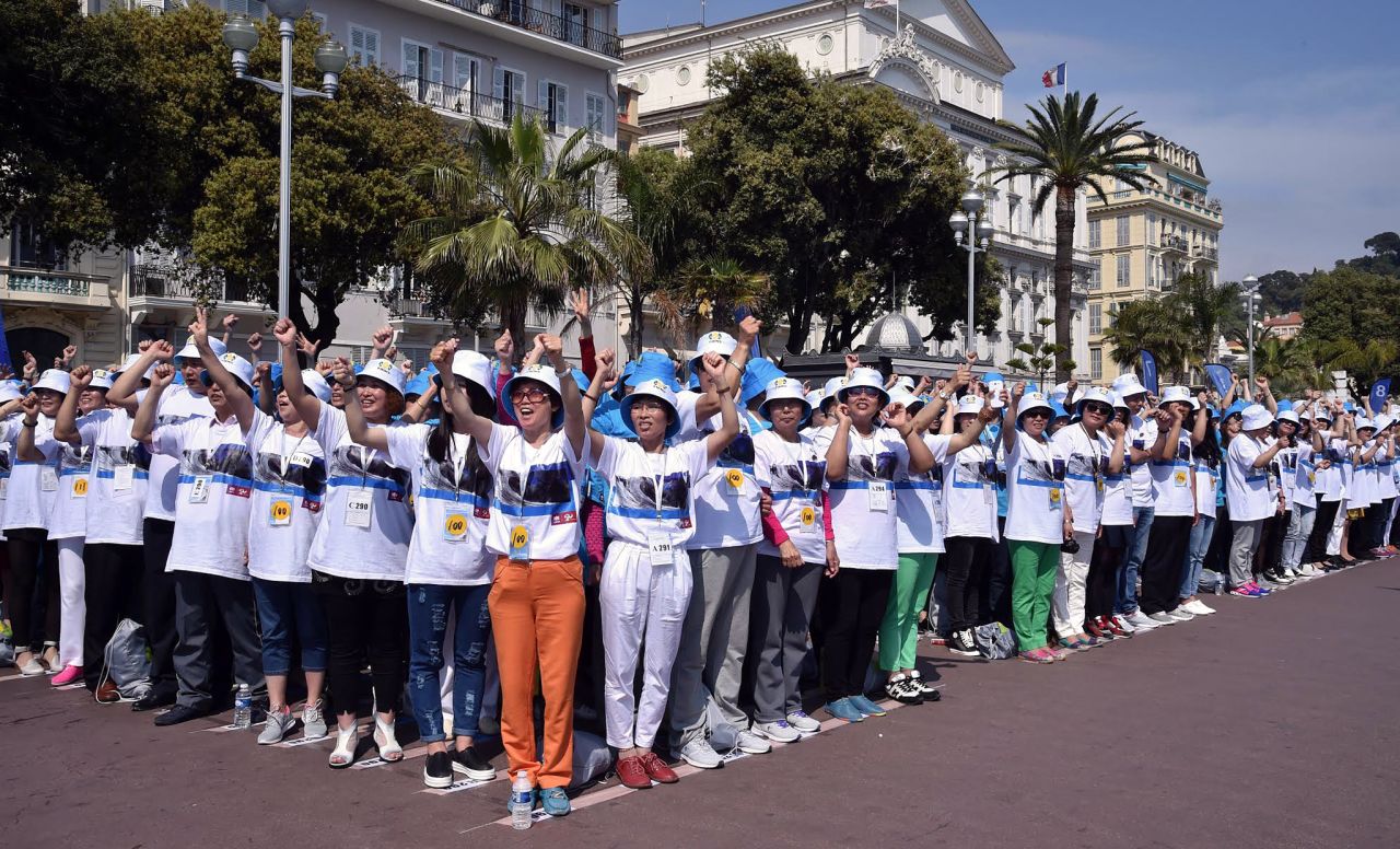 The employees stood together to break a Guinness World Record for the largest human sentence on the Promenade des Anglais in Nice, southeastern France on May 8. 