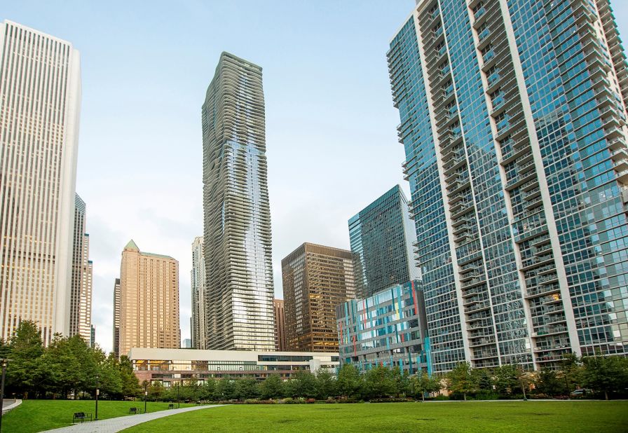 The undulating facade of Jeanne Gang's Aqua tower (center) is steps from Millennium Park and other Chicago landmarks. A one-bedroom apartment available through Airbnb has views of downtown, a full kitchen, modern décor and a 60-inch 3-D TV.