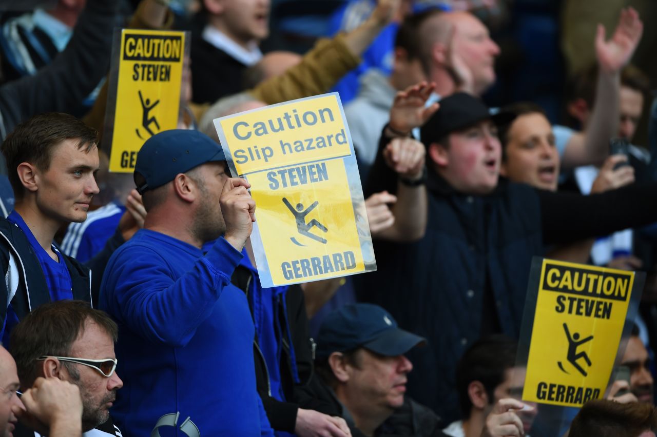 But the conviviality only went so far -- and some Chelsea fans produced laminated cards mocking Gerrard for his slip in the reverse fixture last season that saw Liverpool allow Manchester City to win the Premier League title.