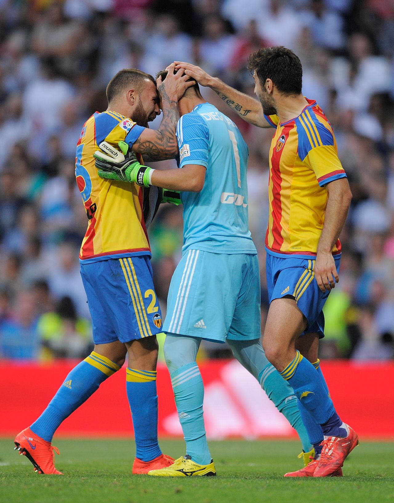 The Valencia goalkeeper is congratulated by his teammates as his save earned the visitors a valuable point as they continue to chase a Champions League place for next season.