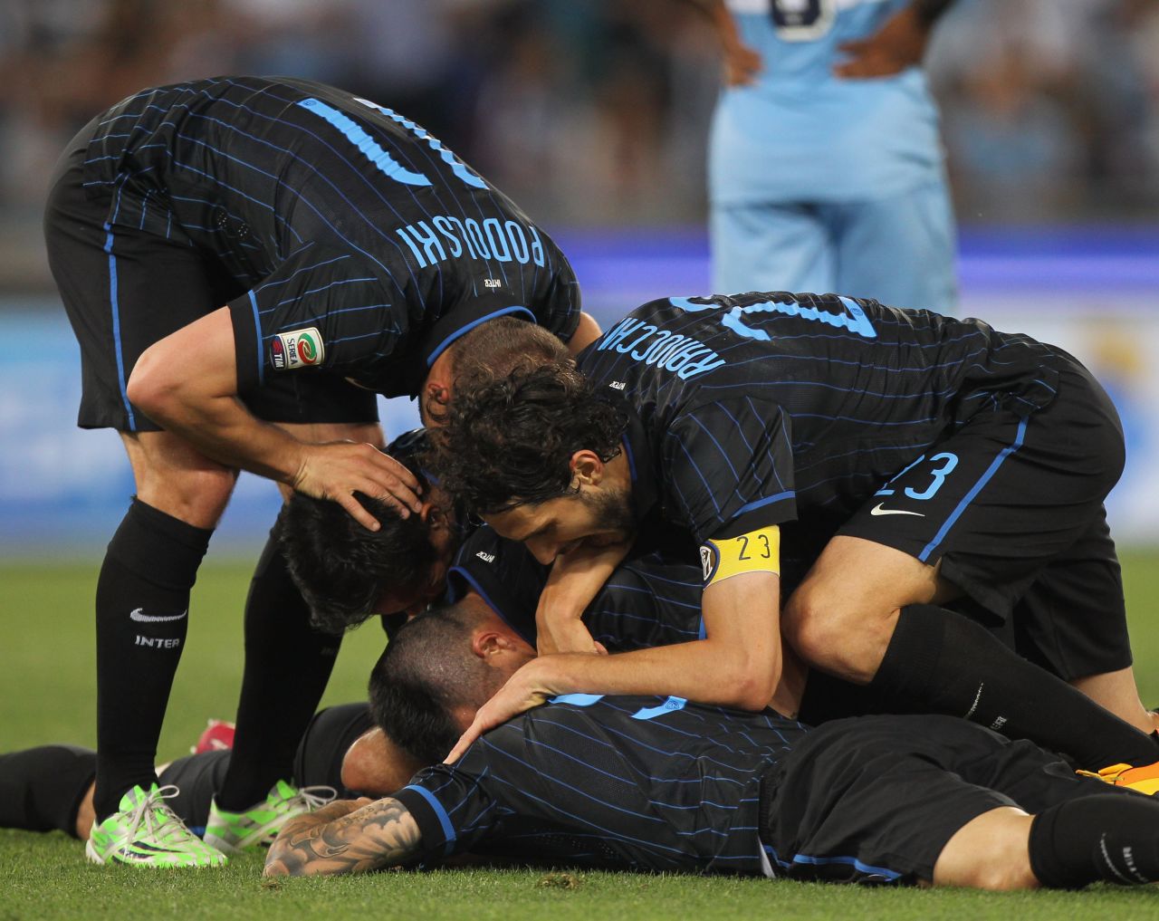 Inter Milan players mob Hernanes after his brace earned the team an important three points, keeping them in the hunt for a Europa League place.