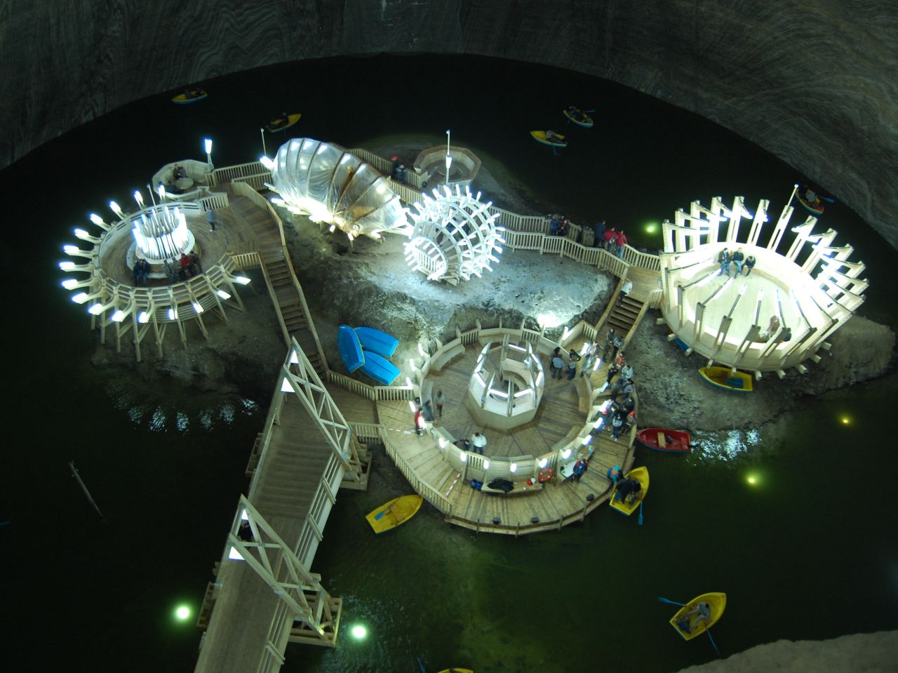 Located in the heart of Transylvania, Salina Turda opened to the public in 1992. Visitors descend 120 meters underground along the same elevator shafts that once hauled salt to reach an underground theme park.