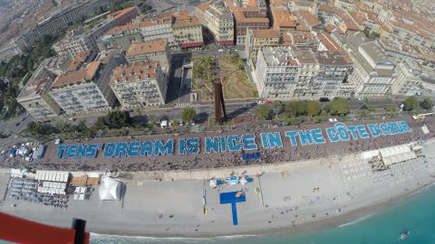 The Chinese company broke a Guinness World Record for building the largest human sentence in Nice, France.