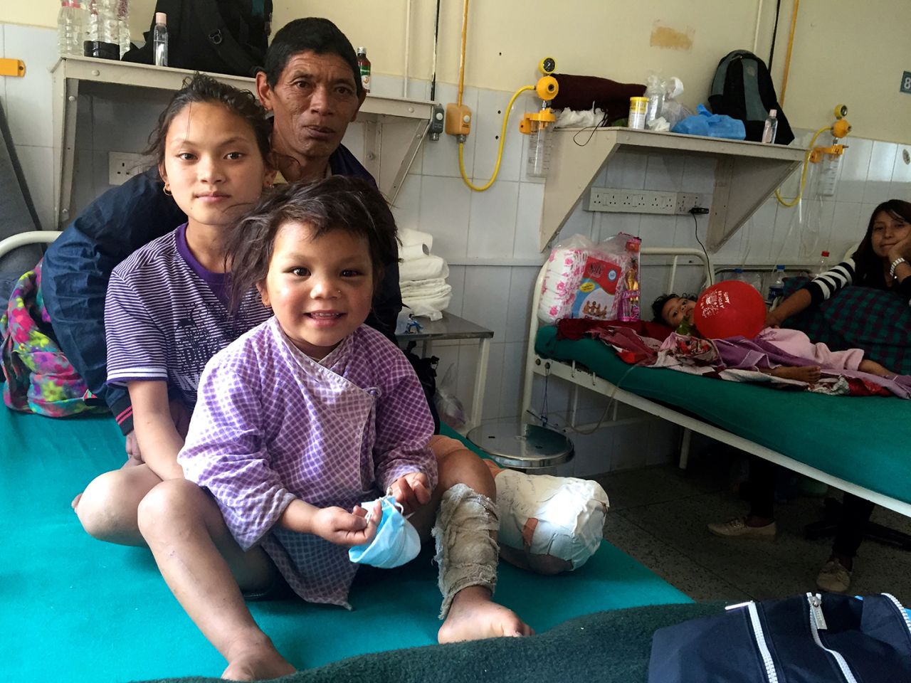 Maya with her father, Bhim Bahardur Gurung, and cousin Manisha at the Tribhuban University Teaching Hospital. 