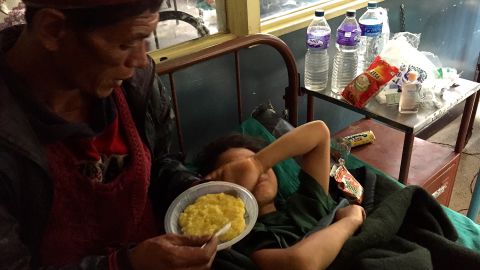 Maya's father tries to feed her lentils and rice, but in the days after the amputation she had little appetite and cried all the time.