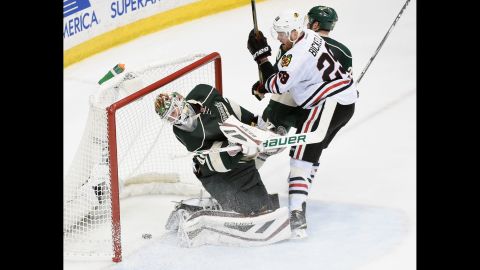 A shot from Chicago's Patrick Kane (not pictured) slips past Minnesota goalie Devan Dubnyk during Game 4 of their NHL playoff series on Thursday, May 7. Chicago won the game 4-3 to complete the series sweep and advance to the Western Conference finals.