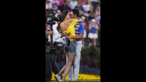 Pro golfer Rickie Fowler kisses his girlfriend, Alexis Randock, after winning the Players Championship in a playoff Sunday, May 10, in Ponte Vedra Beach, Florida.