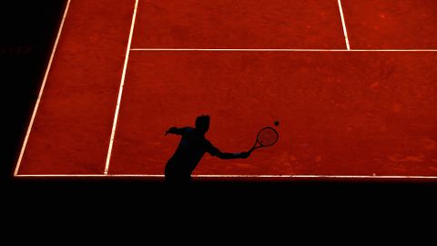 The shadow of Stan Wawrinka is seen on the red clay of Madrid as he returns a shot against Grigor Dimitrov on Thursday, May 7.