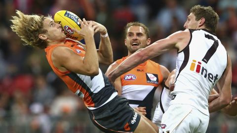 Nick Haynes of the Greater Western Giants, left, catches the ball over Ben McEvoy of the Hawthorn Hawks during an Australian Football League match Saturday, May 9, in Sydney.