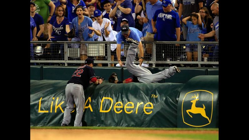 Cleveland's Carlos Santana falls over a tarp as he dives for a catch Tuesday, May 5, in Kansas City, Missouri.