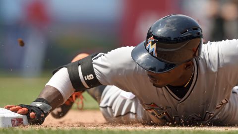 Miami second baseman Dee Gordon tags first base, avoiding a pickoff attempt Wednesday, May 6, in Washington.