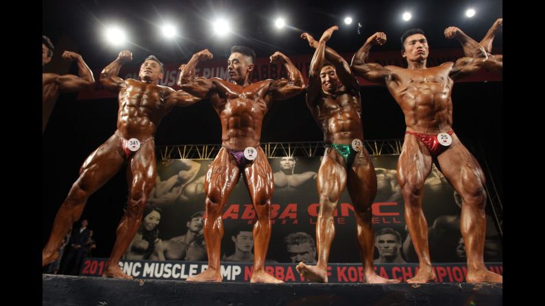Bodybuilders pose for judges during a competition in Seoul, South Korea, on Sunday, May 10.