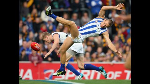 North Melbourne teammates Jack Ziebell, left, and Drew Petrie collide while going for a mark during an Australian League Football match Saturday, May 9, in Hobart, Australia.