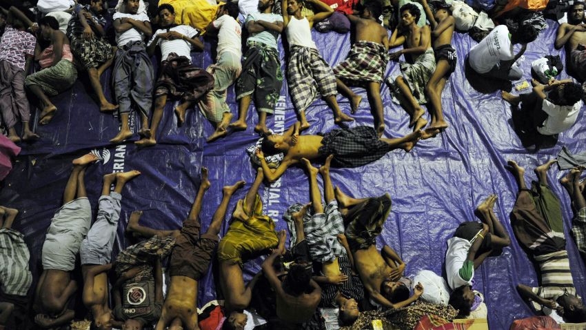 A group of rescued mostly Rohingya migrants from Myanmar and Bangladesh, sleep at a government sports auditorium in Lhoksukon in Aceh province on May 12, 2015 after Indonesian rescuers found their boat carrying 573 passenger stranded in waters off north Aceh province, an official said. Nearly 2,000 boat people from Myanmar and Bangladesh have been rescued or swum to shore in Malaysia and Indonesia, authorities said, warning that yet more desperate migrants could be in peril at sea. AFP PHOTO / CHAIDEER MAHYUDDIN (Photo credit should read CHAIDEER MAHYUDDIN/AFP/Getty Images)