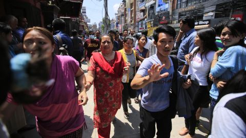 People in Kathmandu hurry along a street after the quake struck on May 12.