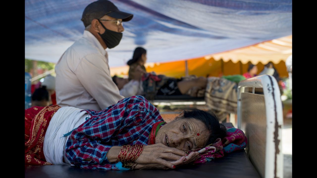 A woman rests at a makeshift hospital in Kathmandu on May 12.