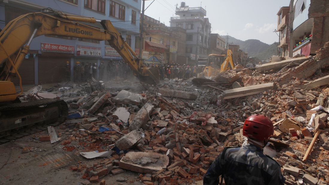 Debris is cleared from the site of a collapsed building in Kathmandu on May 12.