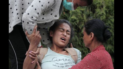 A woman tries to sit up at a hospital in Kathmandu on May 12.