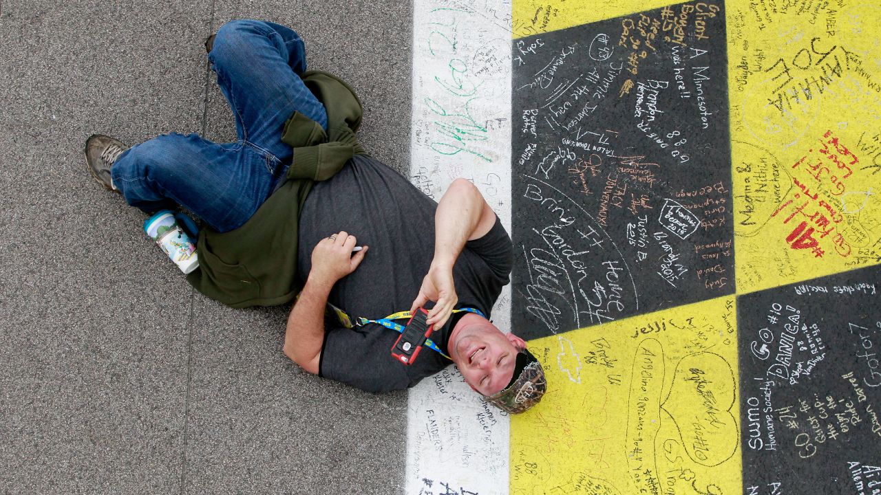 A NASCAR fan takes a selfie on the Kansas Speedway track before the start of the Sprint Cup race there on Sunday, May 9.