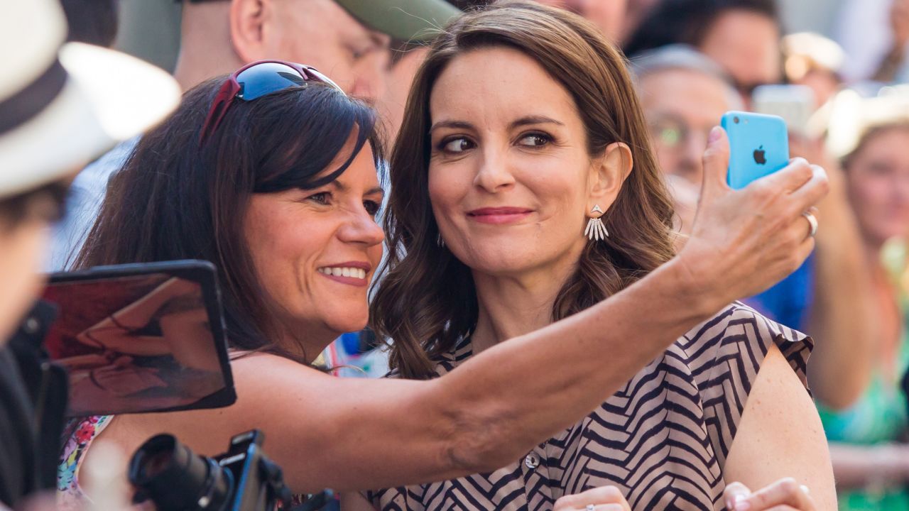 Actress Tina Fey stops for a fan's photo in New York on Thursday, May 7. Fey was appearing on the "Late Show with David Letterman."