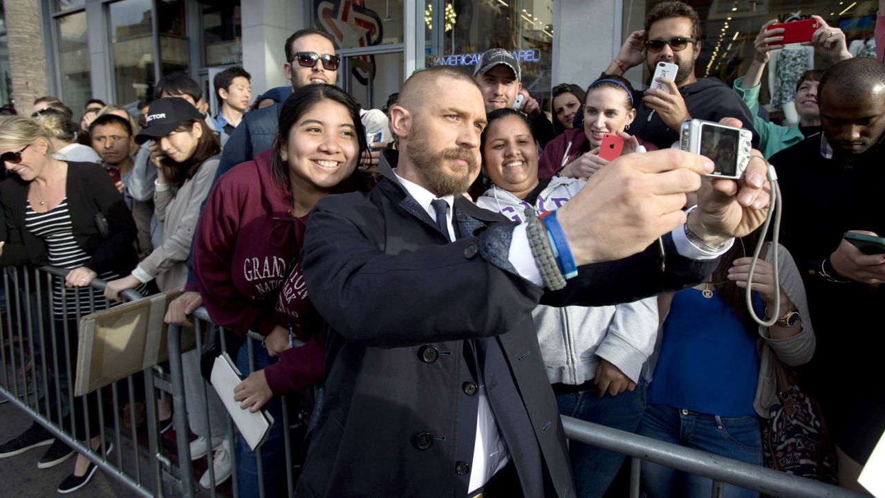 Actor Tom Hardy takes a selfie with fans in Hollywood at the premiere of "Mad Max: Fury Road" on Thursday, May 7.