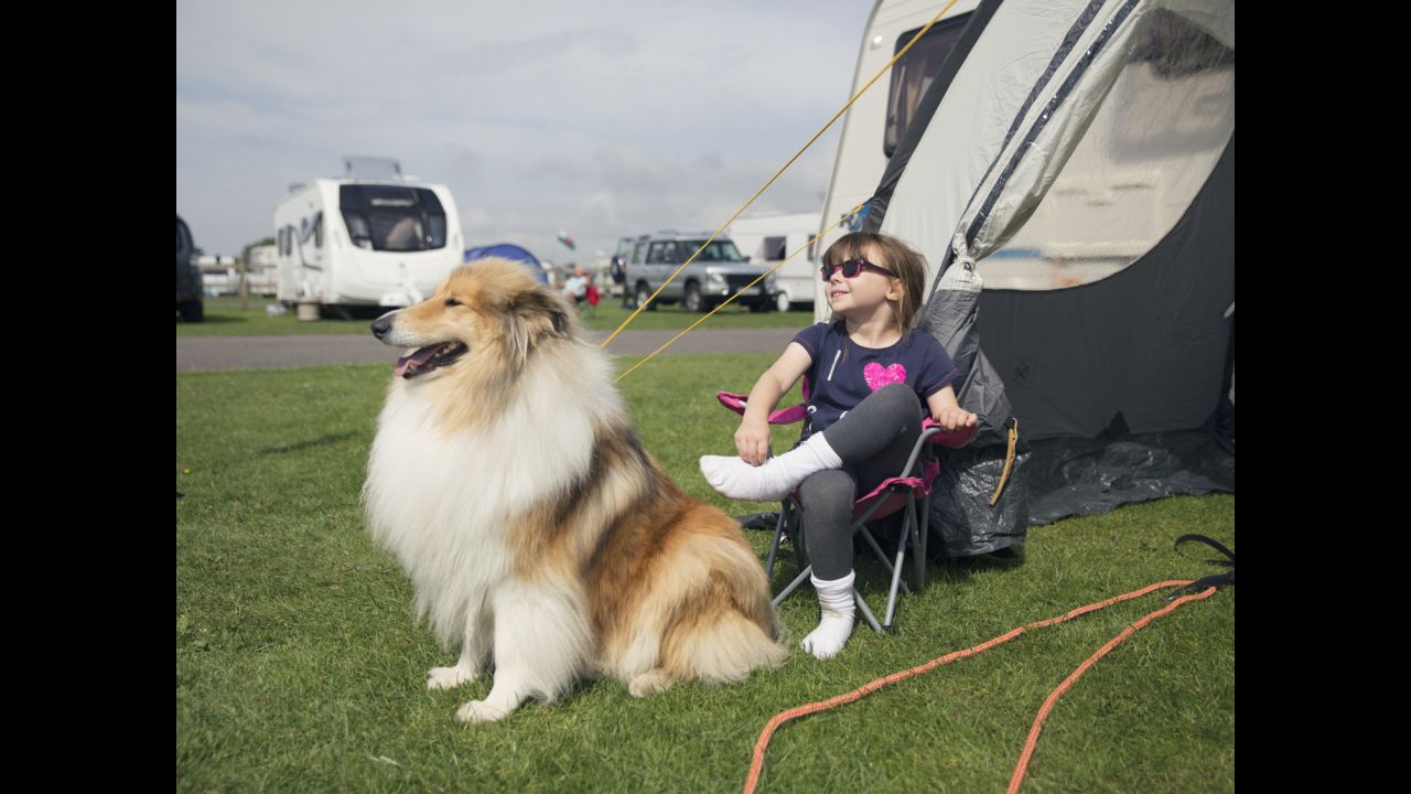 A girl and a dog relax at a caravan site in Somerset, England.