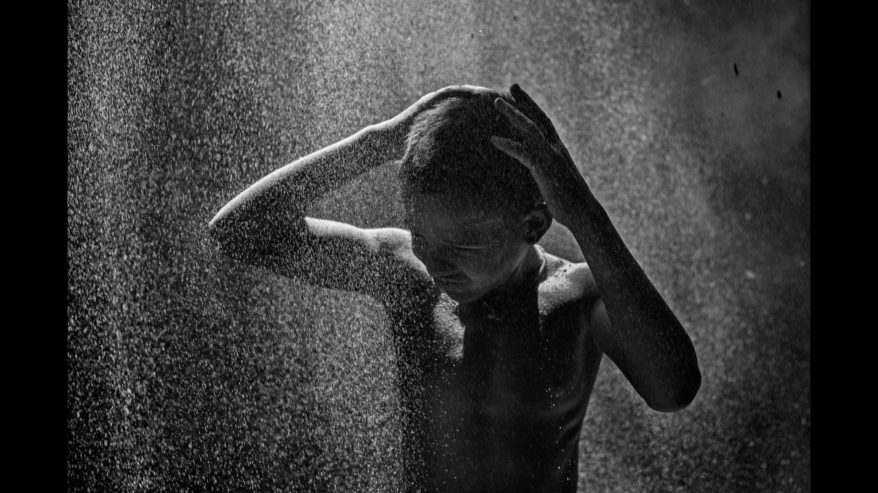 Shakil, 12, is covered with aluminum substance from the factory he works in.