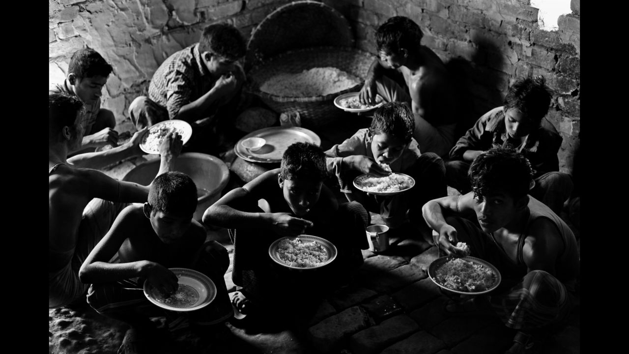 Young brickyard workers eat lunch in Chittagong.