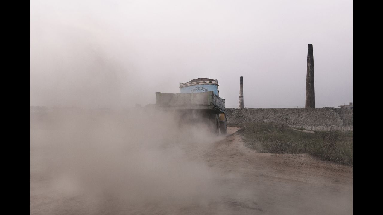 The trucks that load bricks add to the pollution and dust in the area.