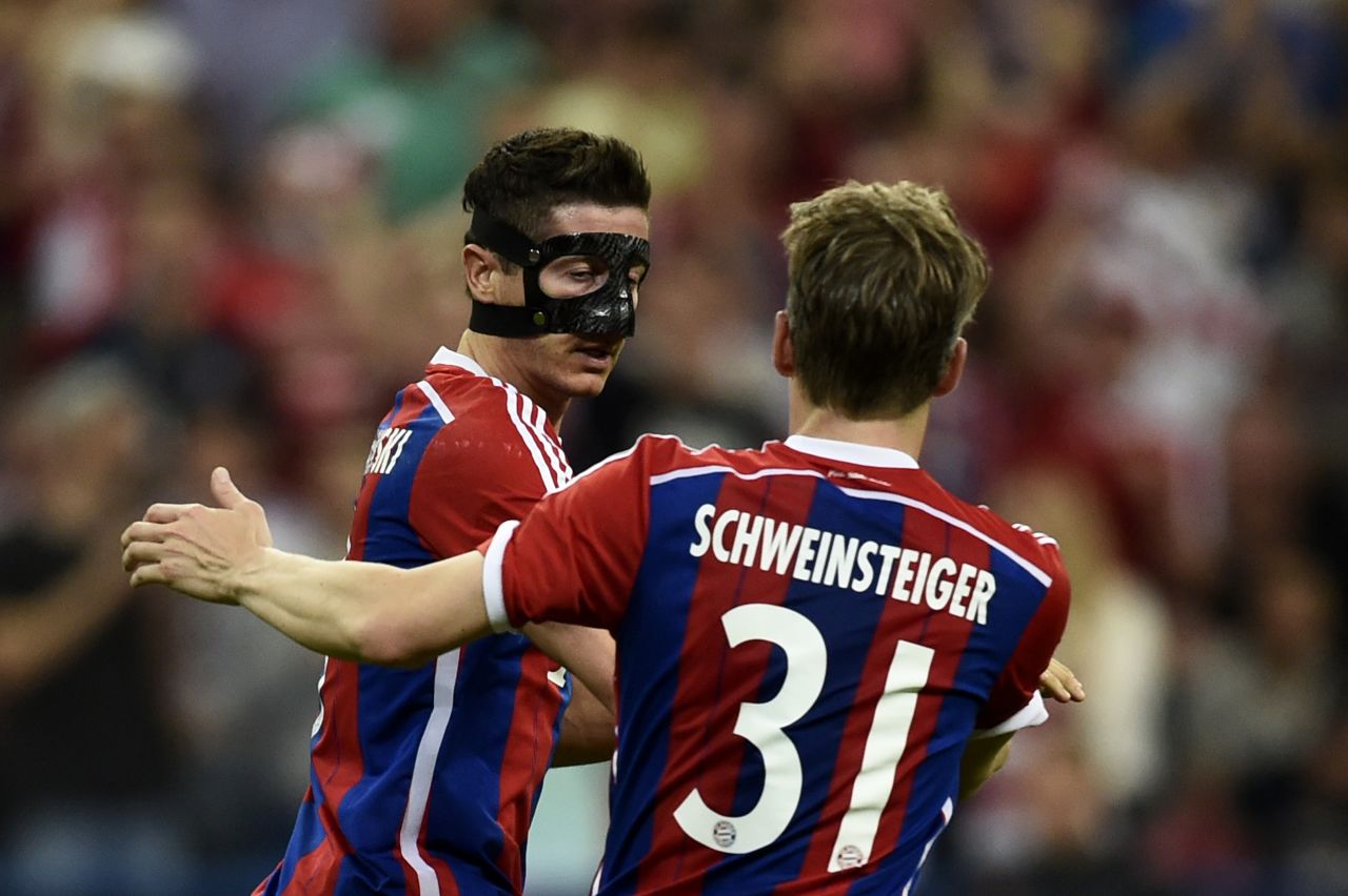Ter Steger denied Bayern several times but Lewandowski (left) -- playing with a broken jaw and busted nose -- equalized in the 59th minute. 